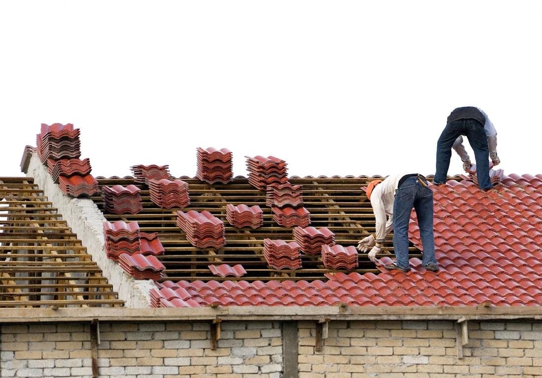 Roofing crew working on tile roof materials